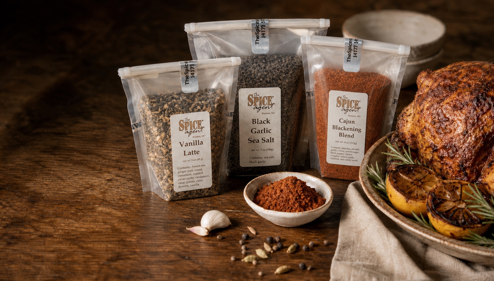 Three Spice Agent pouches beside roast chicken and charred lemons